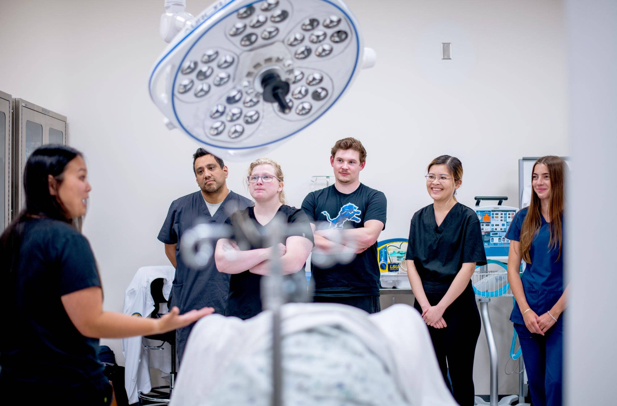 Students learn in a simulated emergency room with a faculty member